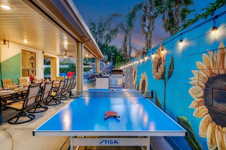 Challenge friends to a match on the ping pong table beside a vibrant mural wall.