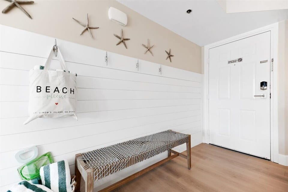 Front entry bench and hooks to hang all of your beach gear.