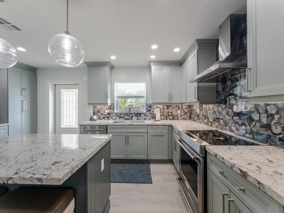 High-end chef's kitchen with modern coastal design and premium appliances at Mystic Waters.