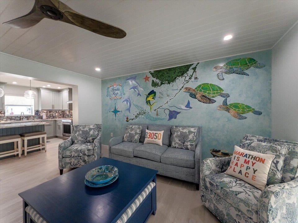 Modern coastal living area with upscale furnishings and panoramic water views.