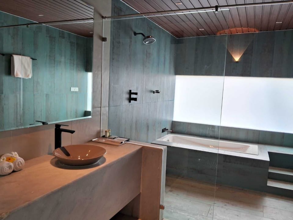 Signature Villa | Bathroom | Rainfall showerhead, hair dryer, slippers, towels