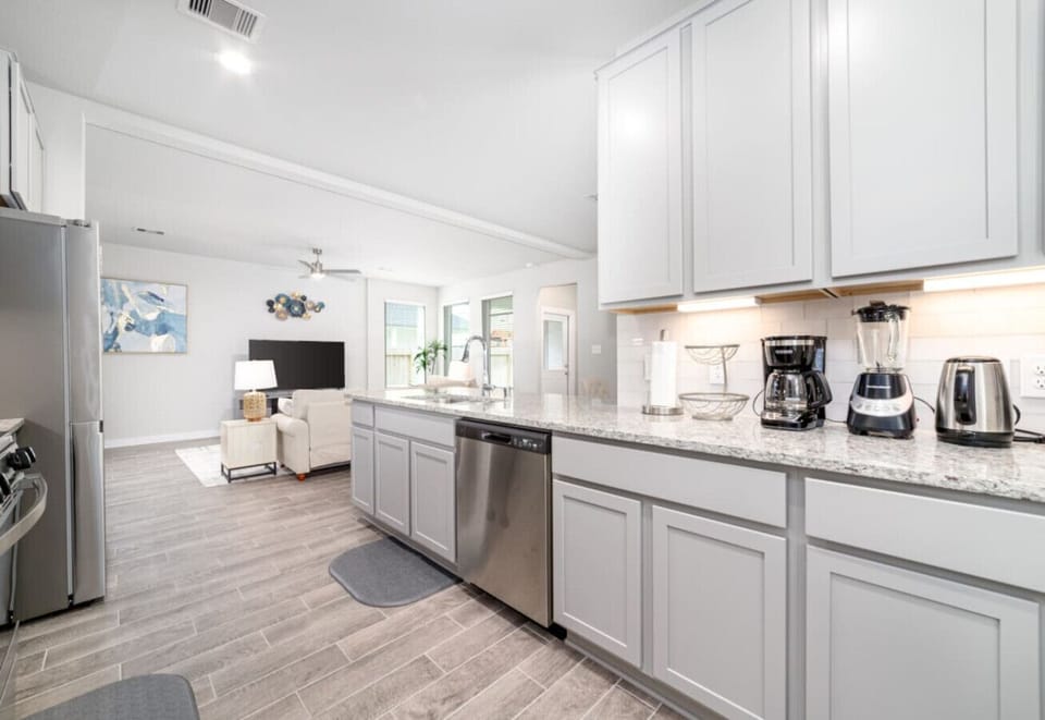 Spacious kitchen with ample counter space and modern appliances, perfect for cooking and entertaining.