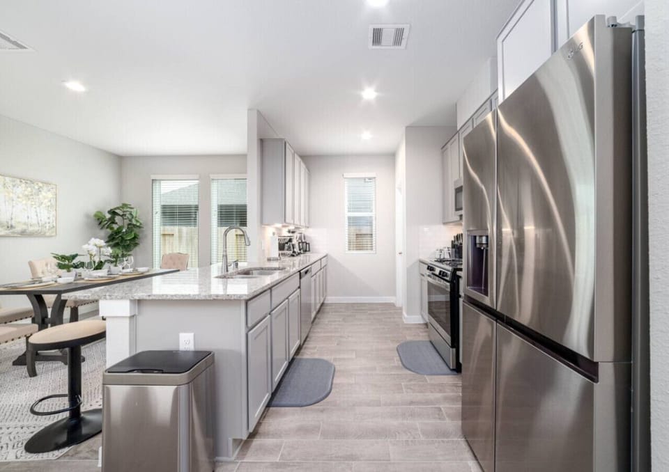 Cook and gather in this spacious kitchen, equipped with modern appliances and plenty of counter space for all your culinary needs.