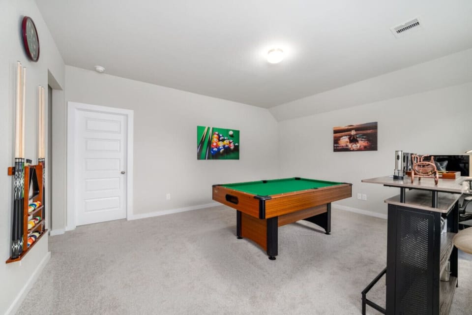 Entertainment space with a billiard table and other games for hours of fun and relaxation.