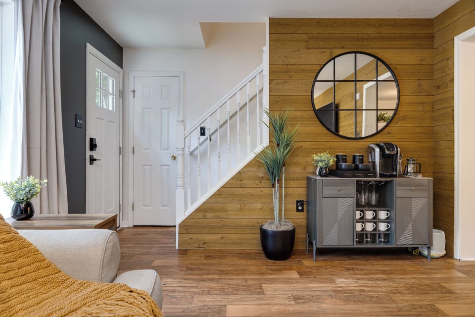 Bright entryway with a stylish coffee station to greet you.