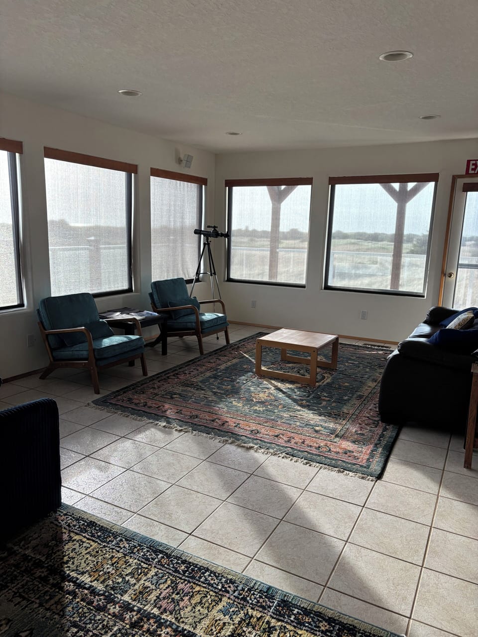 You'll love this bright dining space with its cozy seating and beautiful Persian rug, perfect for sharing meals.