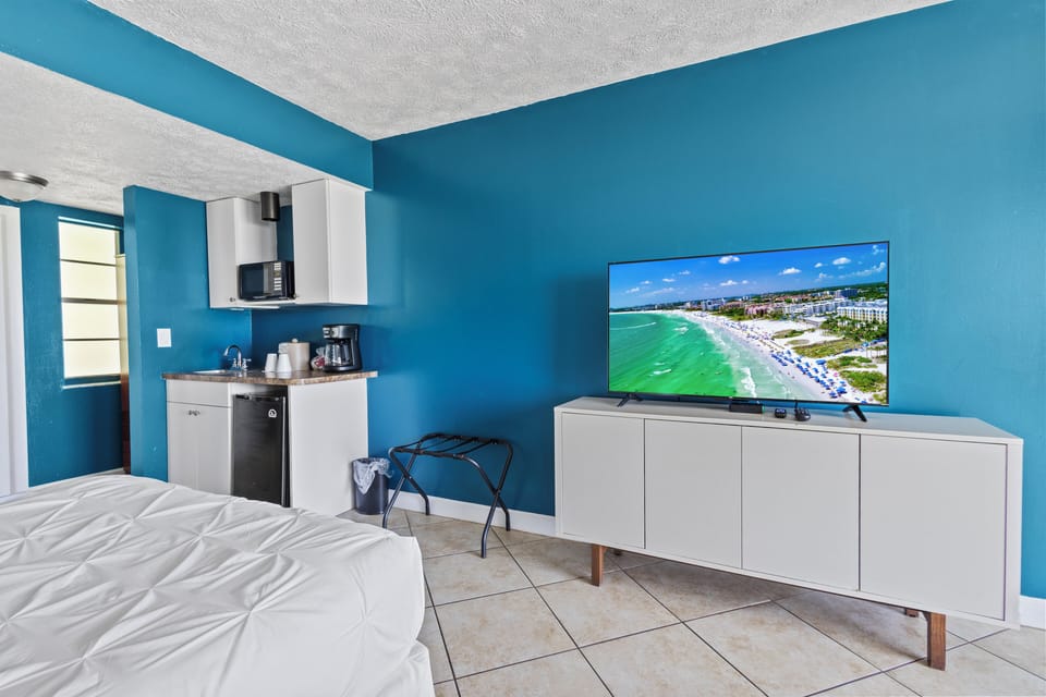 Amenities include a smart TV with cable, a mini fridge, a microwave, and a coffee maker.