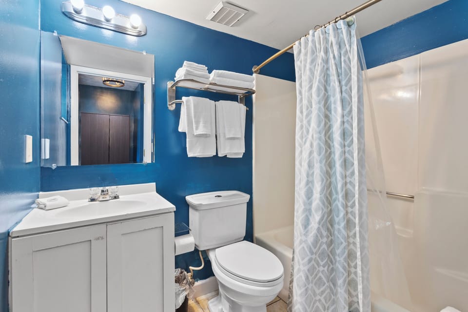 The ensuite bathroom has a tub and shower.
