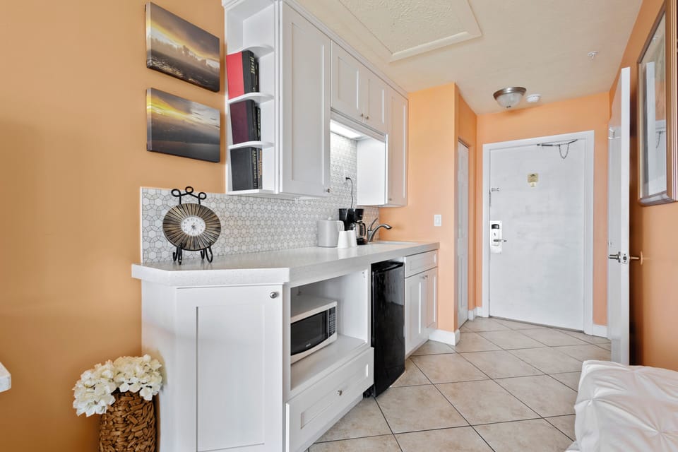 Amenities include a smart TV with cable, a mini fridge, a microwave, and a coffee maker.