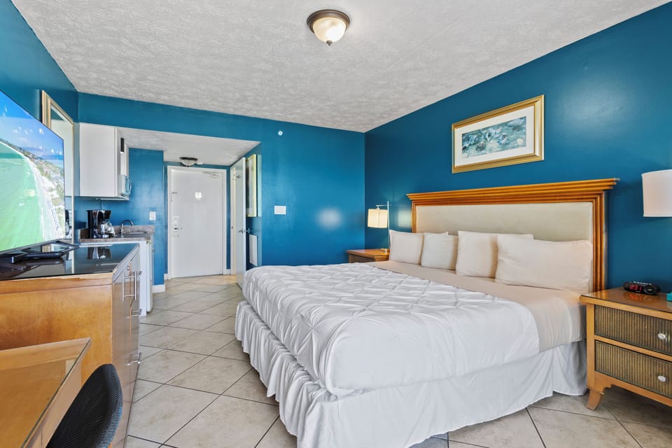Amenities include a smart TV with cable, a mini fridge, a microwave, and a coffee maker.