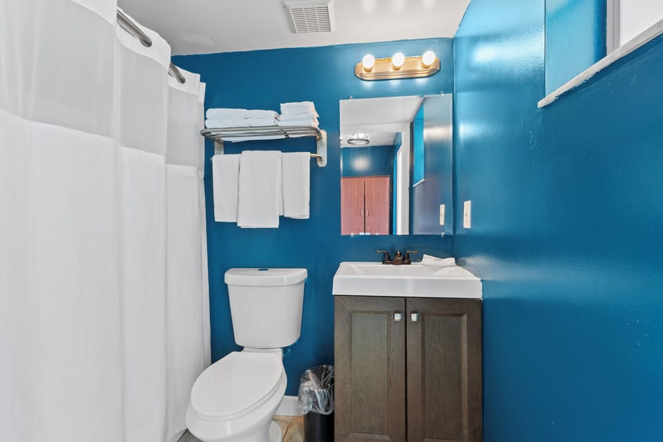 The ensuite bathroom has a tub and shower.