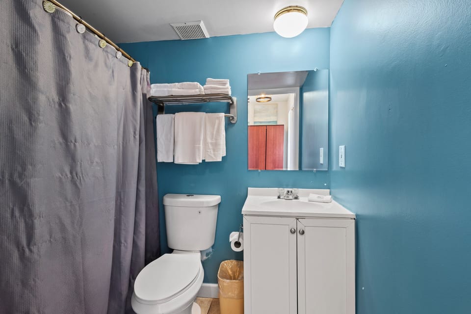 The ensuite bathroom has a tub and shower.