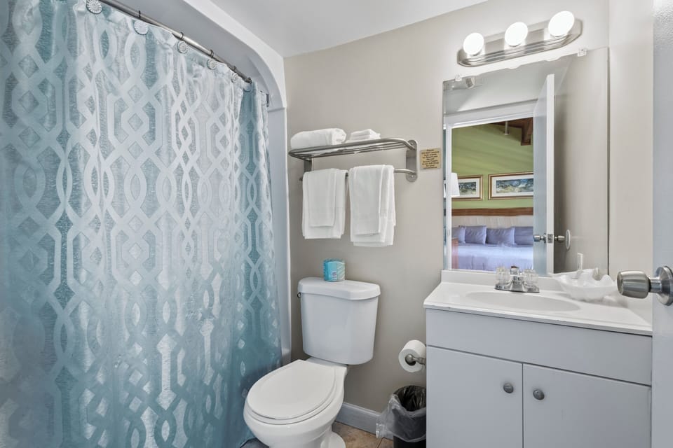 The ensuite bathroom has a tub and shower.