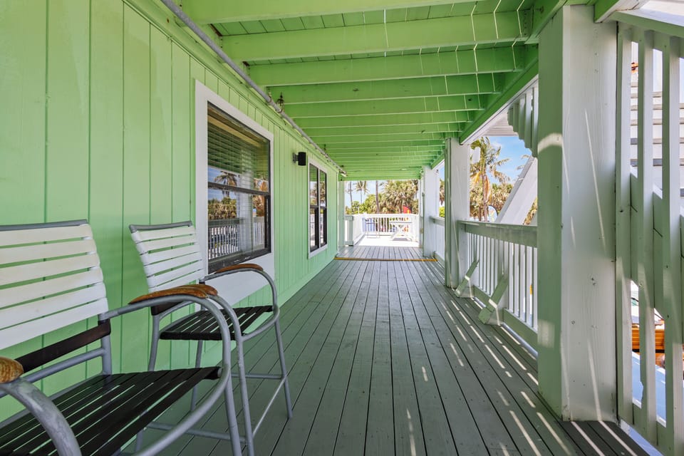 The room has a window facing toward the ocean.
