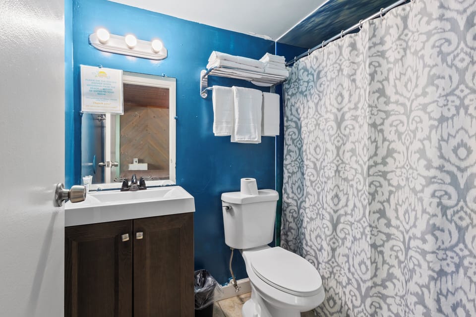 The ensuite bathroom has a shower.