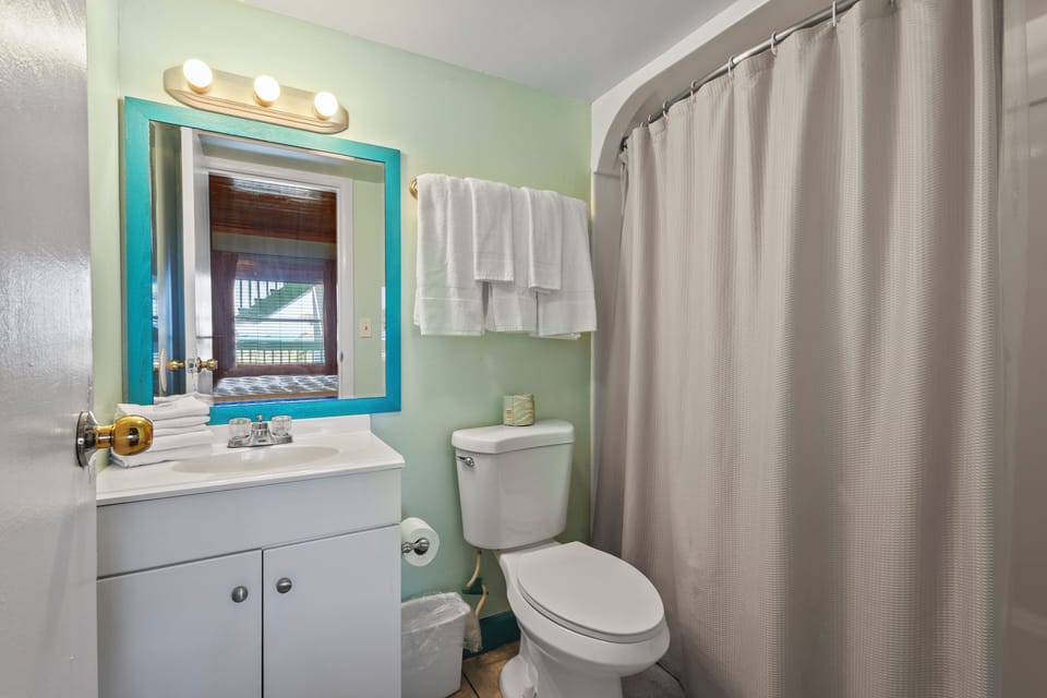 The ensuite bathroom has a tub and shower.