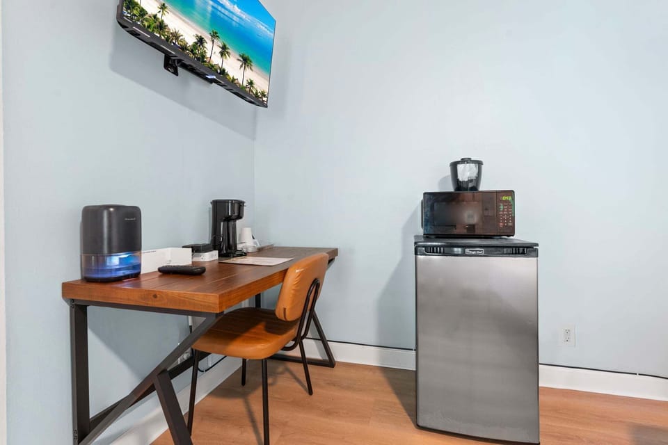 Amenities include a smart TV with cable, a mini fridge, a microwave, and a coffee maker.
