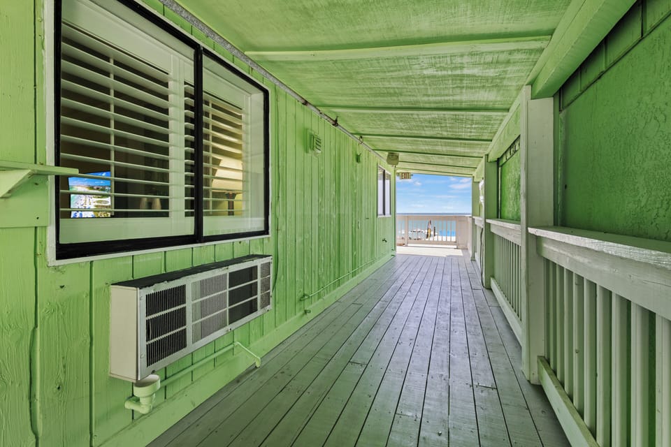 The room has a shared balcony toward the ocean.