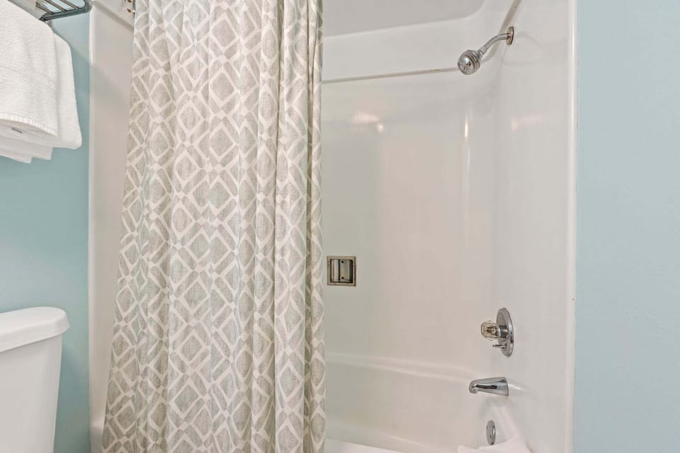 The ensuite bathroom has a tub and shower.