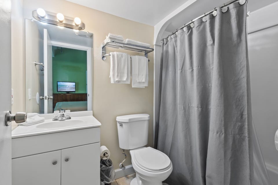The ensuite bathroom has a tub and shower.