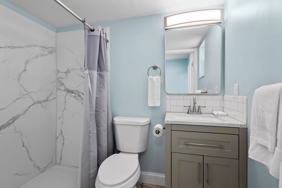 The ensuite bathroom has a shower.