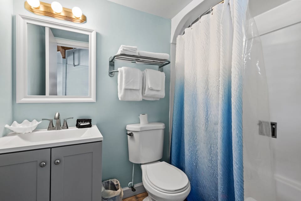 The ensuite bathroom has a tub and shower.
