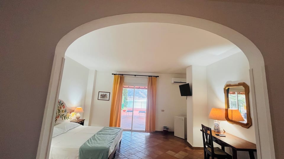 Family Room, 1 Bedroom, Sea View | In-room safe, desk, laptop workspace, soundproofing