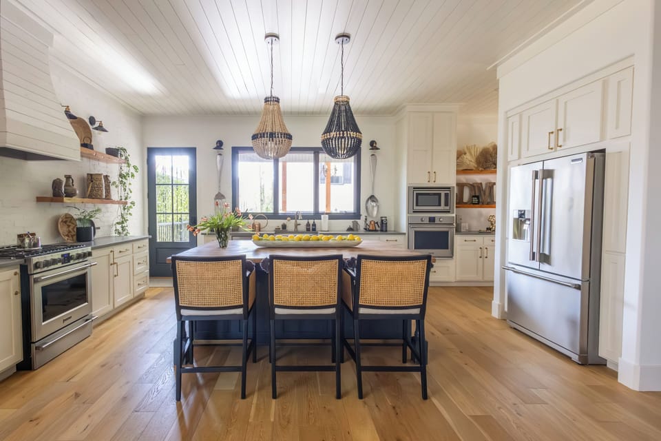 View of kitchen island with comfy bar seating for three.