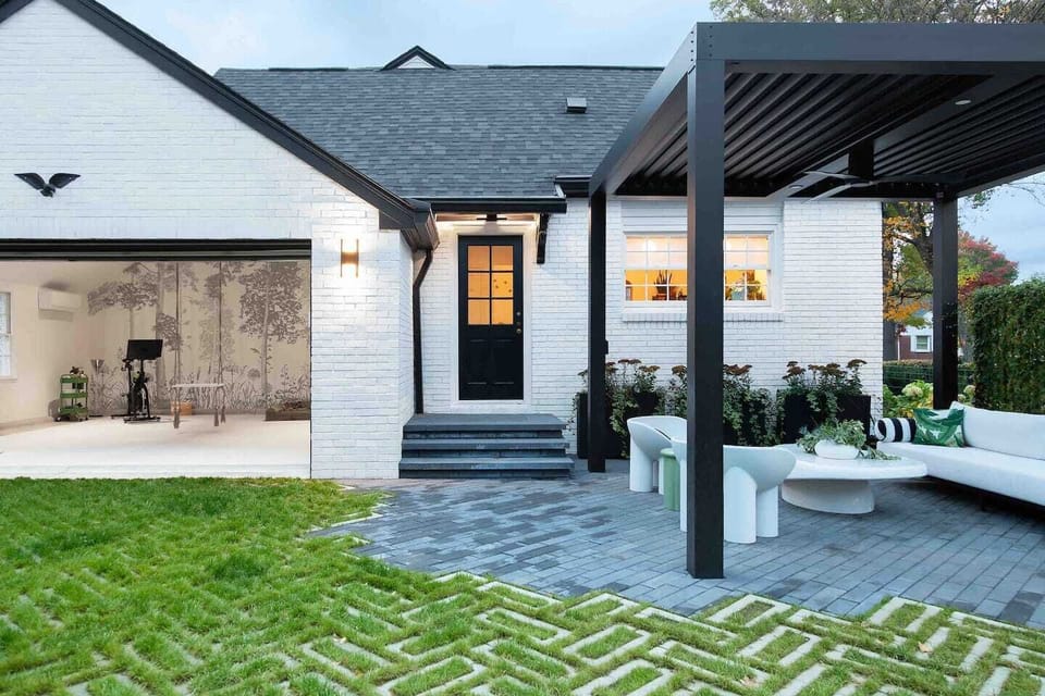 Welcome to Ivy Grace. Where indoor/outdoor living is at its finest. Back entry, pergola and view of studio.