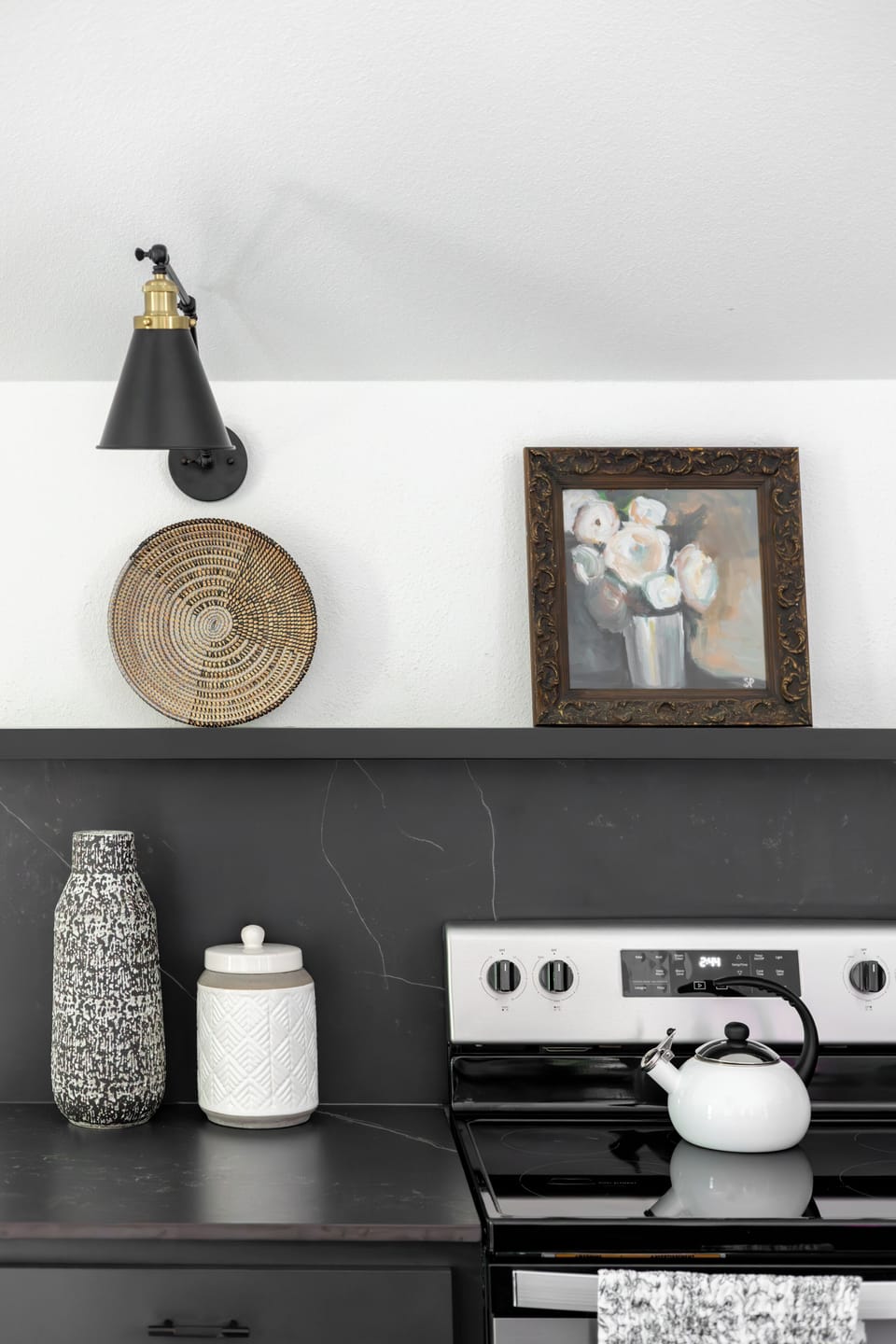 Vintage kitchen art with stylish lighting and floating shelf.