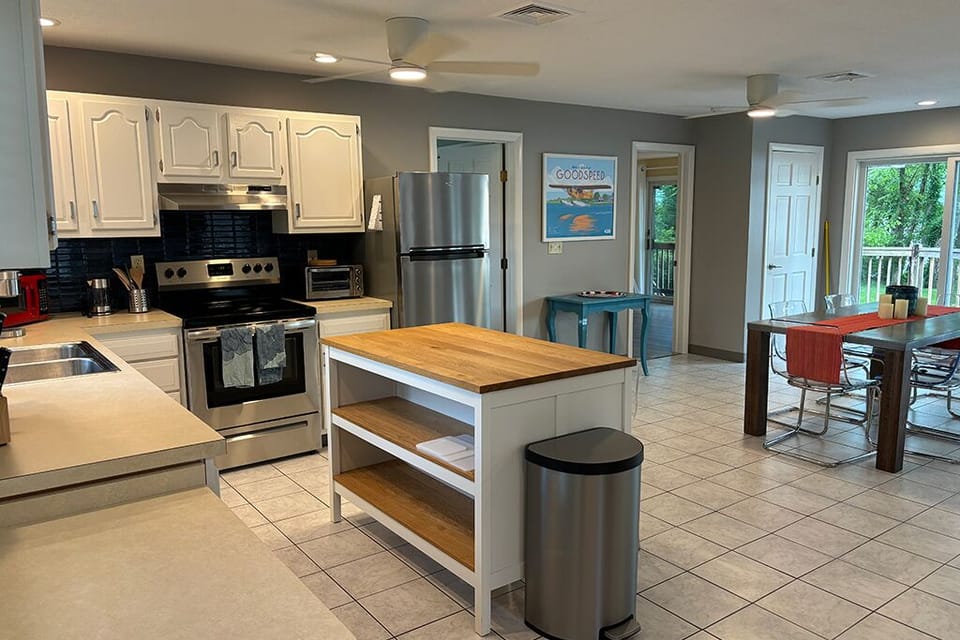 The kitchen, looking toward the river, open to the indoor dining and living room