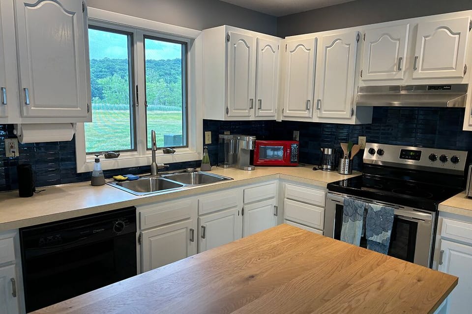 The kitchen has a dishwasher, Keurig machine, kettle, and toaster oven