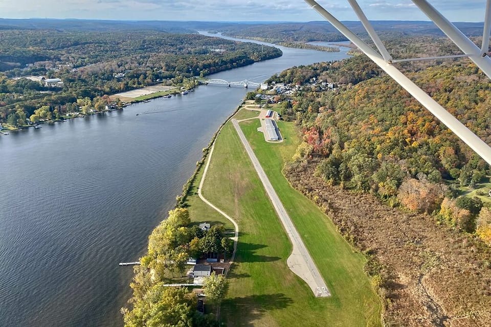 The house is located between the river and the end of runway 32.