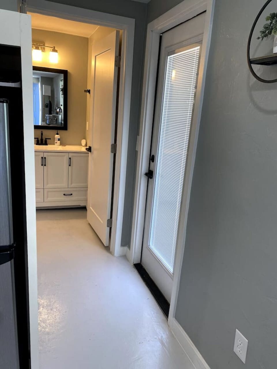 Entrance to bathroom and door leading to private patio