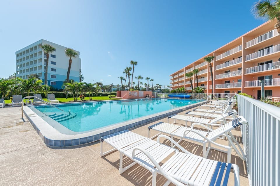 Sparkling heated pool surrounded by loungers for a refreshing swim