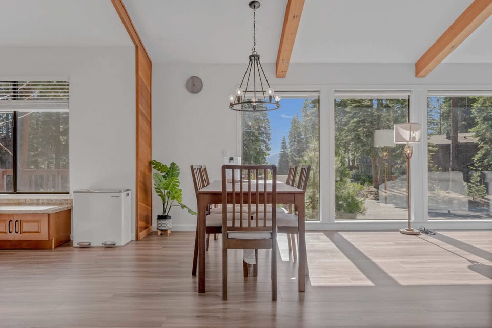 Dining Room: 6-person dining table, large windows, situated between kitchen and living room
