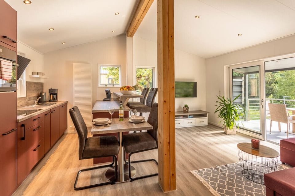 Open-plan kitchen & dining area bathed in natural light, w/ garden views just steps away.