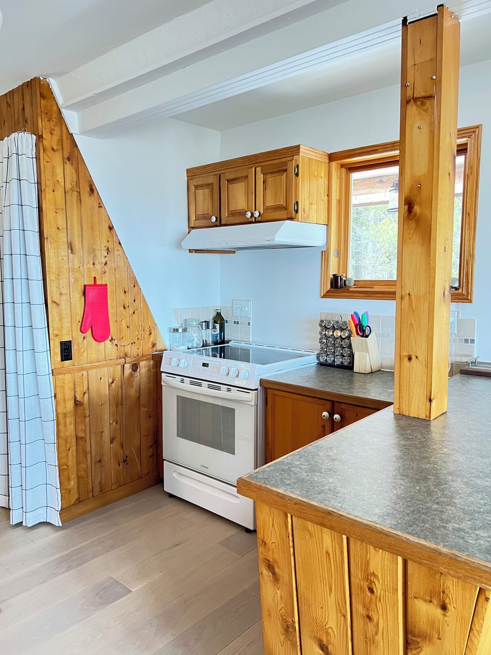 Fully equipped kitchen with cottage charm—featuring a gas range, plenty of prep space, and a window view to inspire your inner chef.
