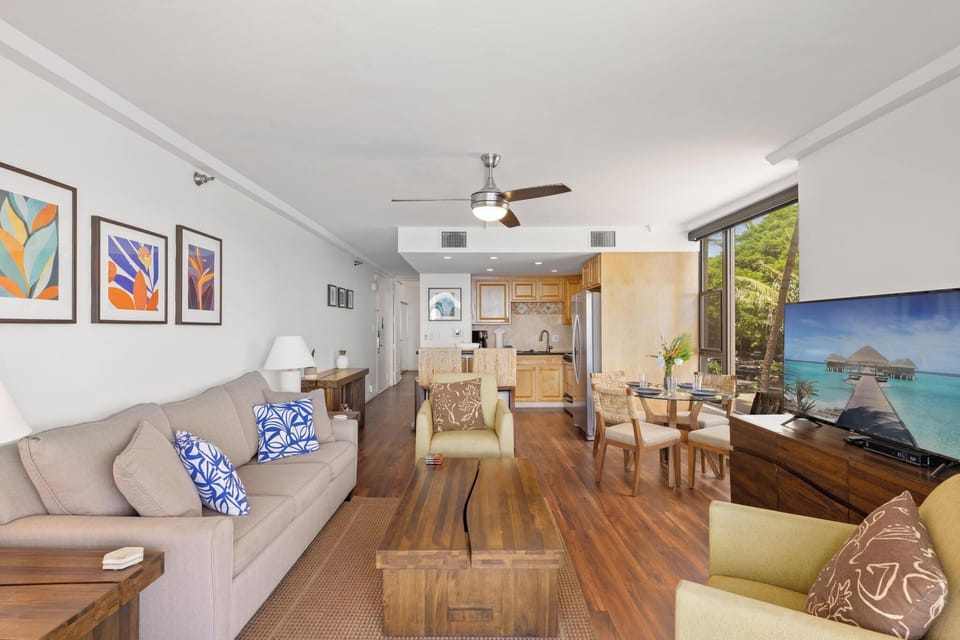 Soak in ocean views from the bright living room, adorned with colorful art and cozy furnishings for a serene escape.