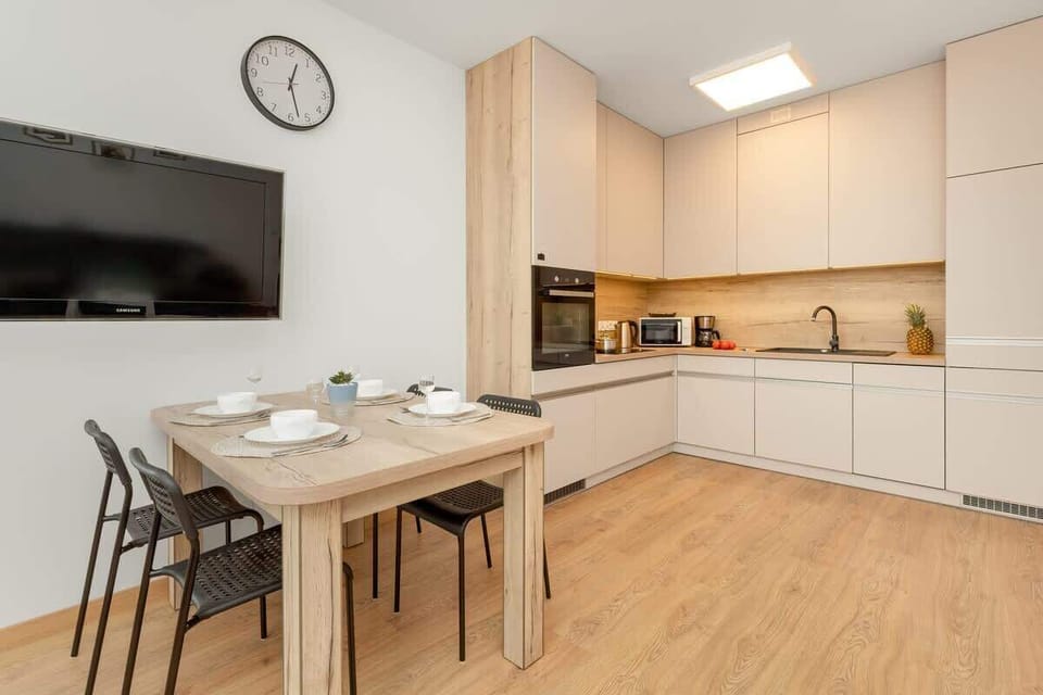 The sleek design of the kitchenette blending seamlessly with the living area.