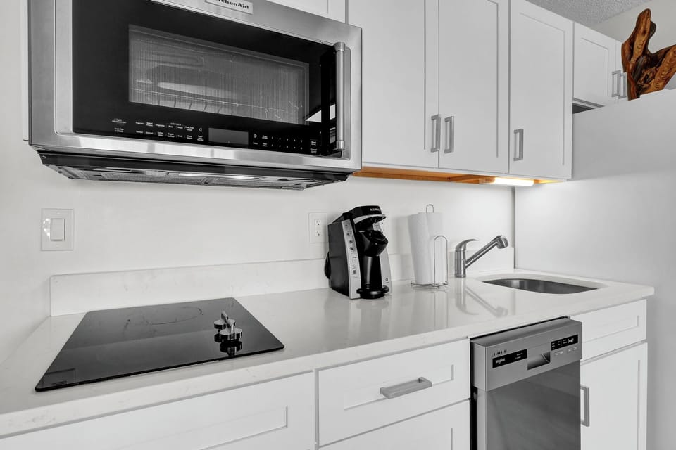 Your fully equipped kitchen features modern appliances including a microwave, dishwasher, and coffee maker - everything you need to prepare meals during your stay.
