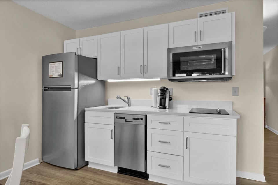 Your modern kitchenette features sleek stainless steel appliances and crisp white cabinets, perfect for preparing meals during your stay.