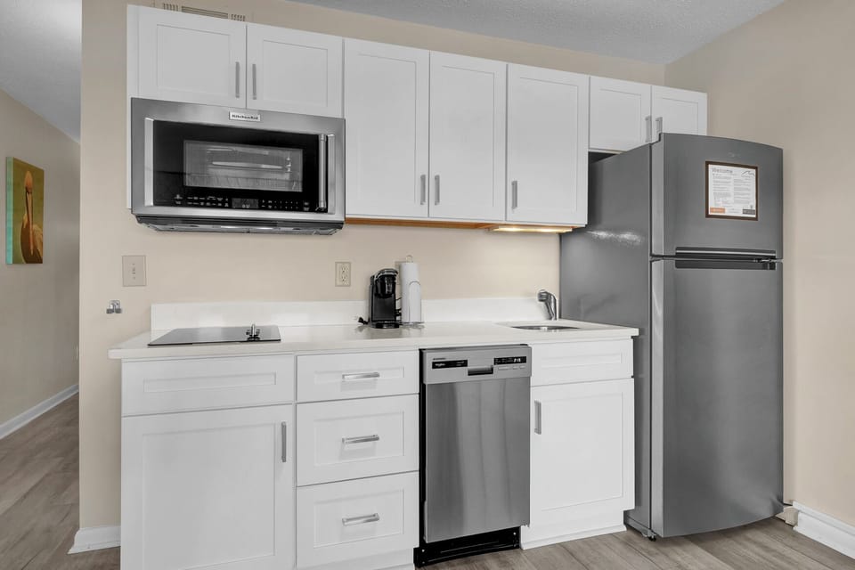 Your fully equipped kitchen features modern stainless steel appliances, crisp white cabinetry, and everything you need to prepare meals during your stay.