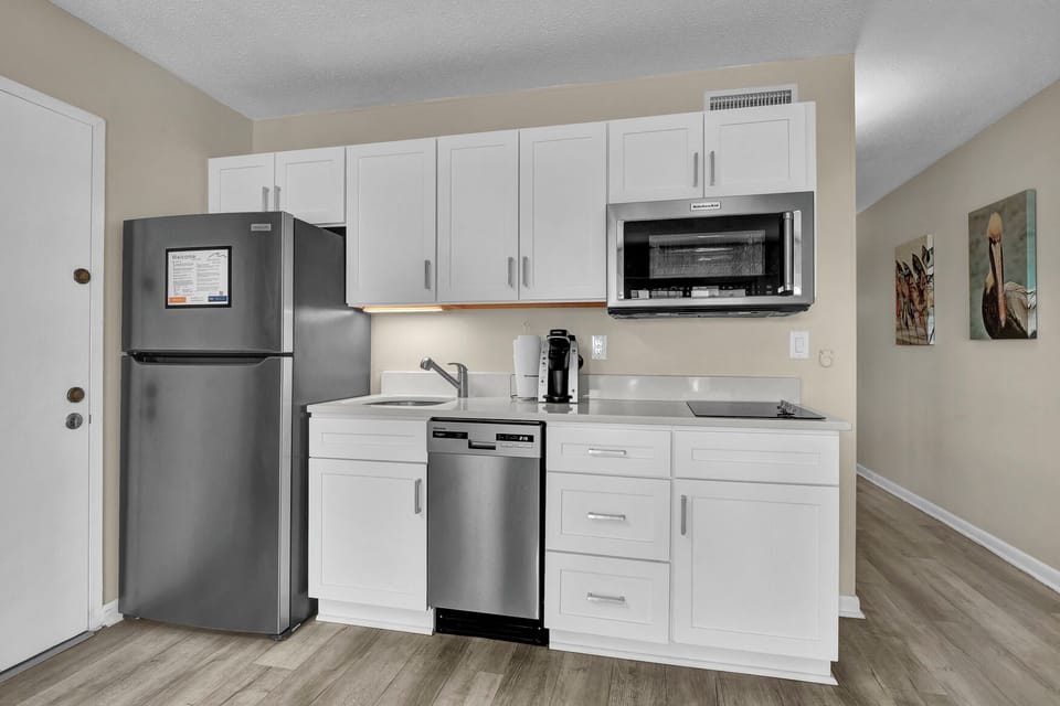 Your well-equipped kitchenette features modern stainless steel appliances and plenty of cabinet space for all your cooking needs.