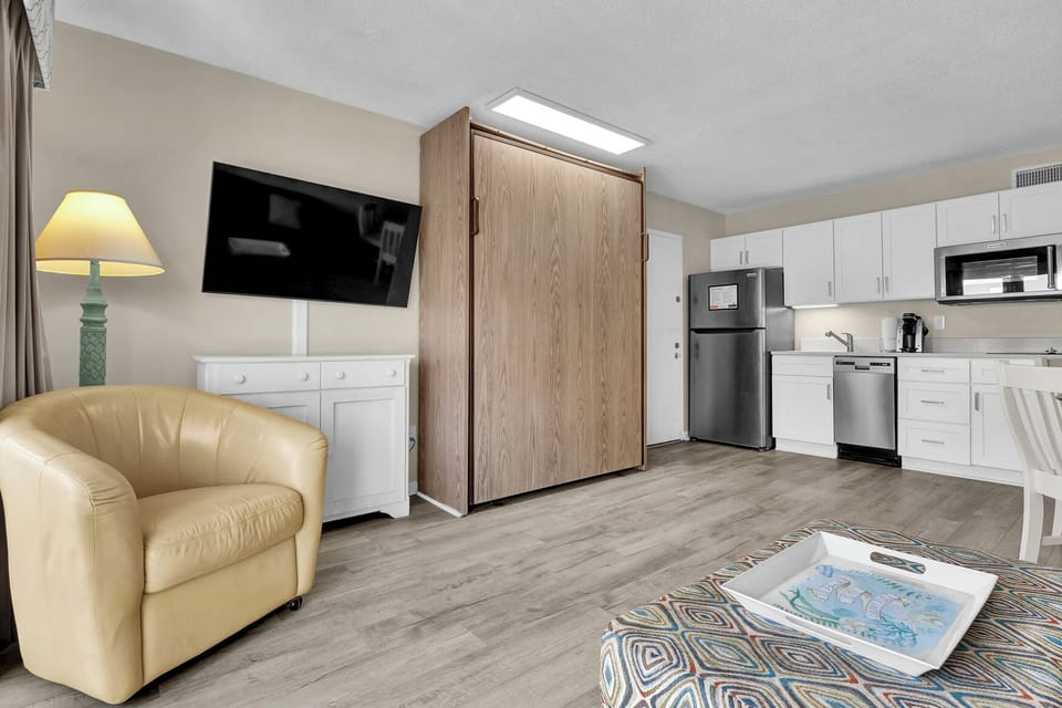 Your spacious studio combines comfort and convenience with a Murphy bed, full kitchen, and cozy seating area.