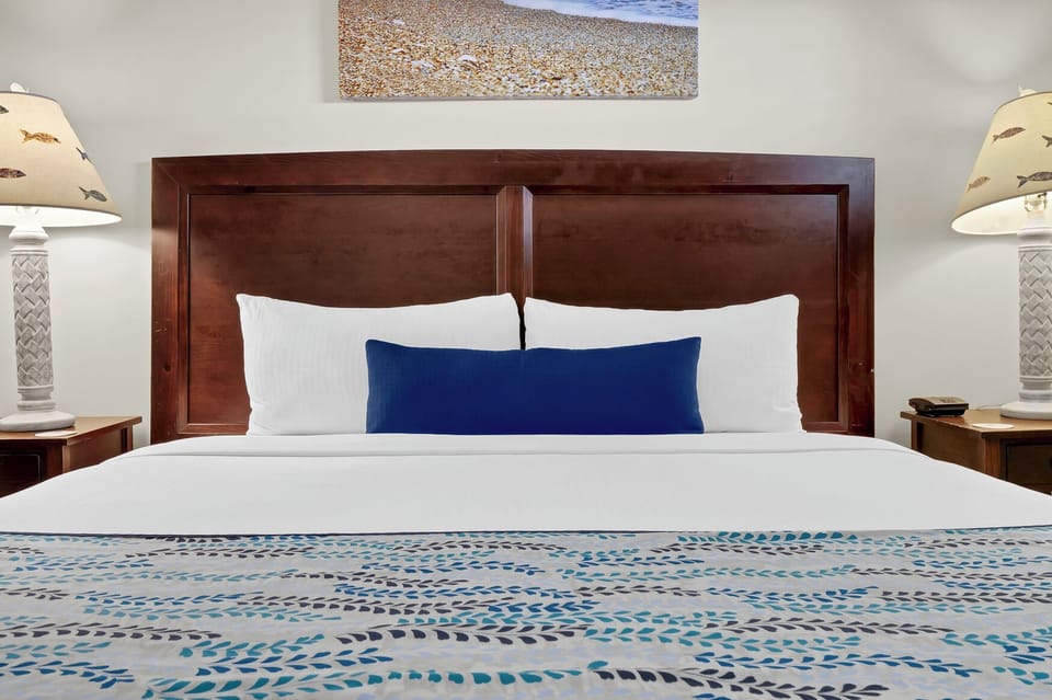 Sink into crisp white linens and coastal blues in your peaceful bedroom retreat, complete with thoughtful bedside lighting.