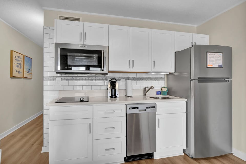 Your fully equipped kitchen features modern appliances and subway tile backsplash, perfect for preparing meals during your stay.
