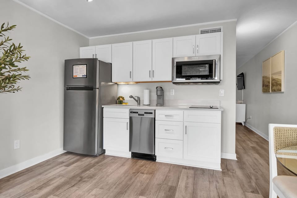Kitchen, with two burner induction stove top, microwave and convection oven, sink, Keurig, and dishwasher