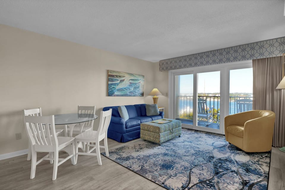 Unwind in your coastal haven with lake views through sliding doors, perfect for morning coffee or evening relaxation on your private balcony.