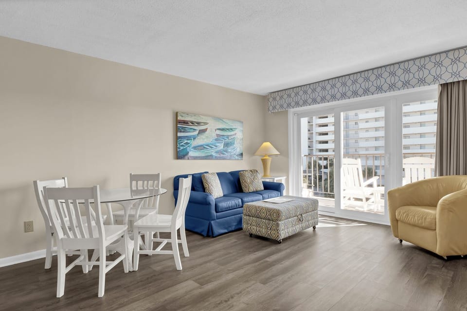 Relax in your bright, airy living space with comfortable seating and a private balcony overlooking the city skyline.